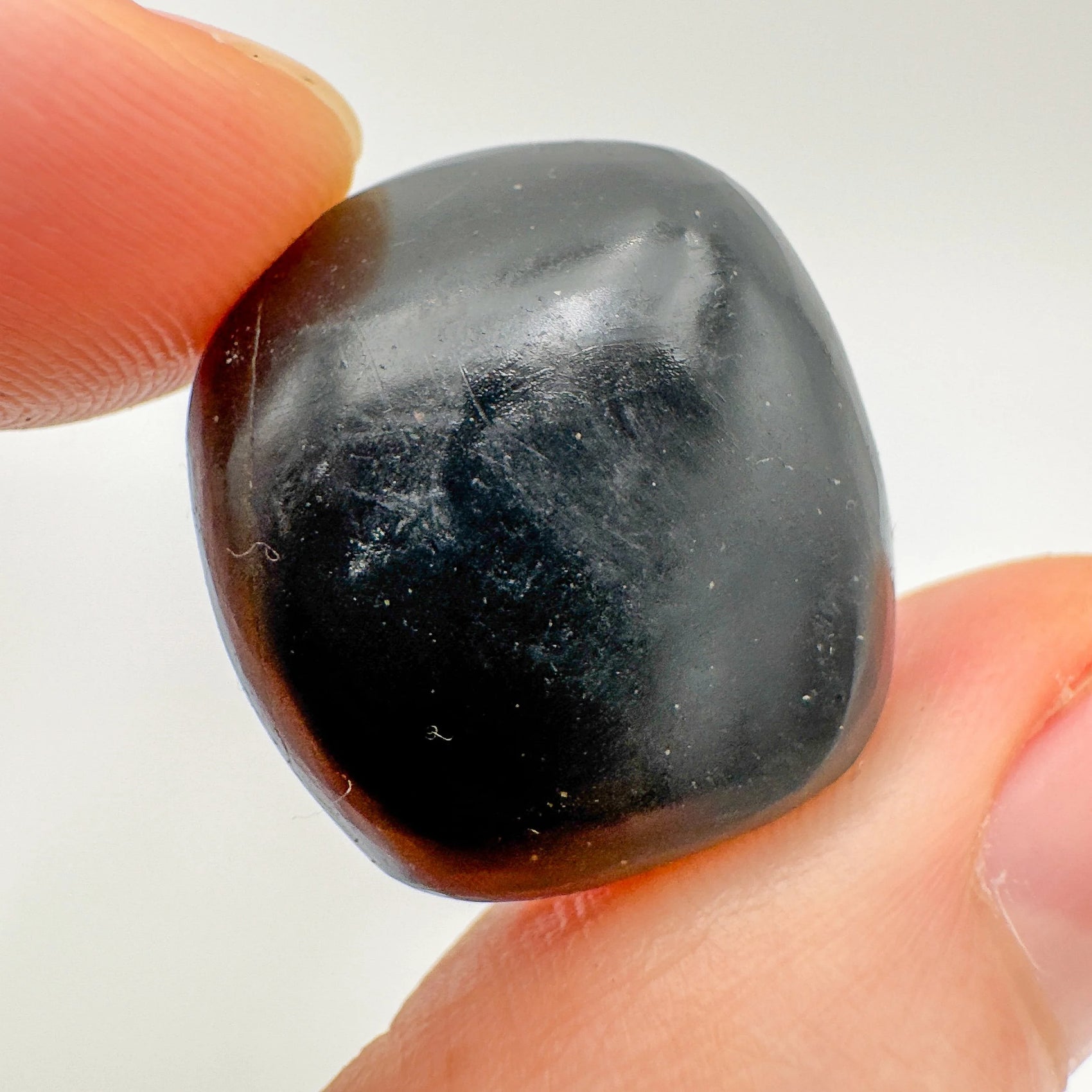 Back view of Grade AA Black Onyx tumbled stone showing natural surface