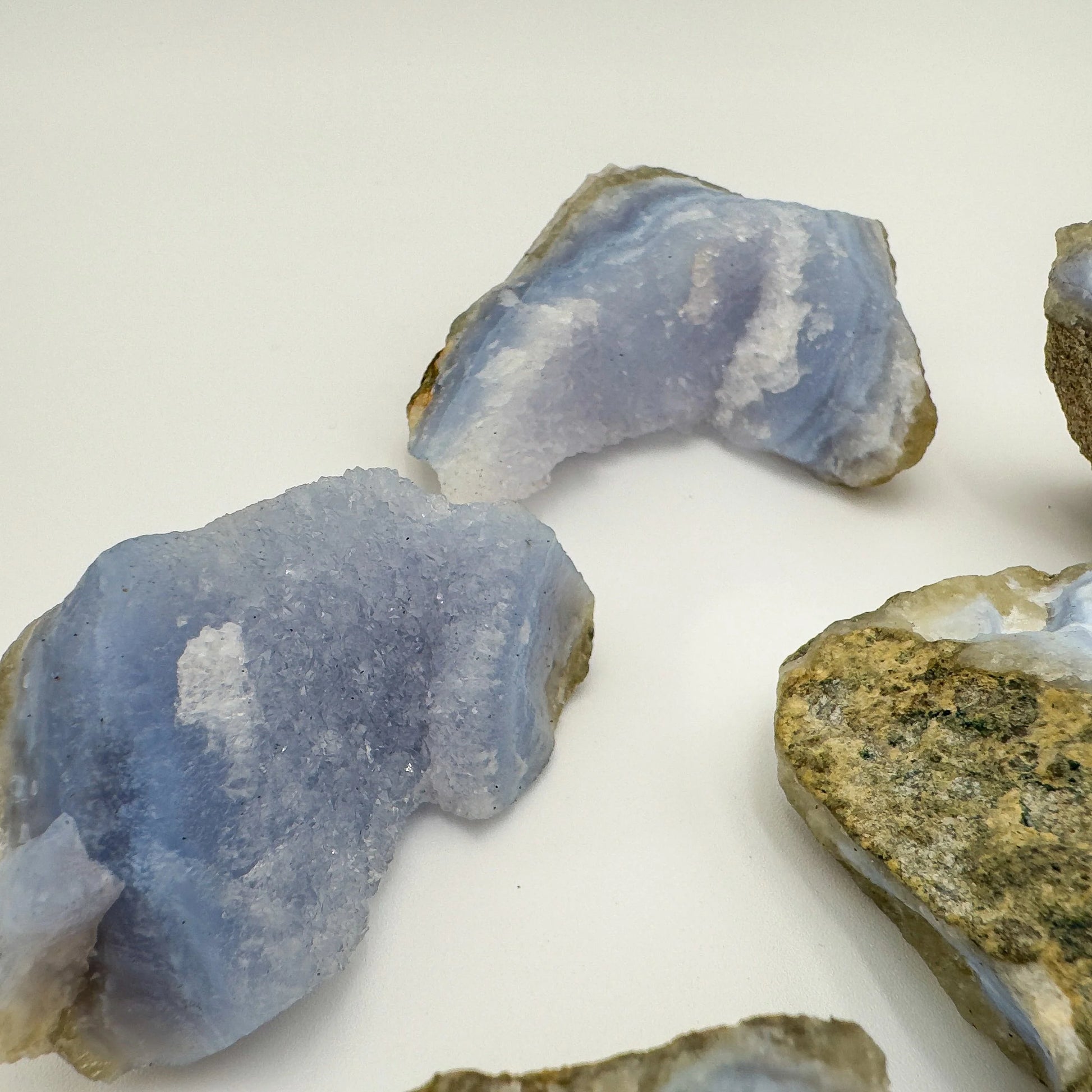 Palm-scale view of a Blue Lace Agate raw geode to support Stress Relief and Emotional Healing.
