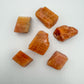 Up-close view of Orange Calcite raw stone, showing natural texture.