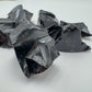 Profile view of Grade AA Black Obsidian raw stone, sourced from Argentina.