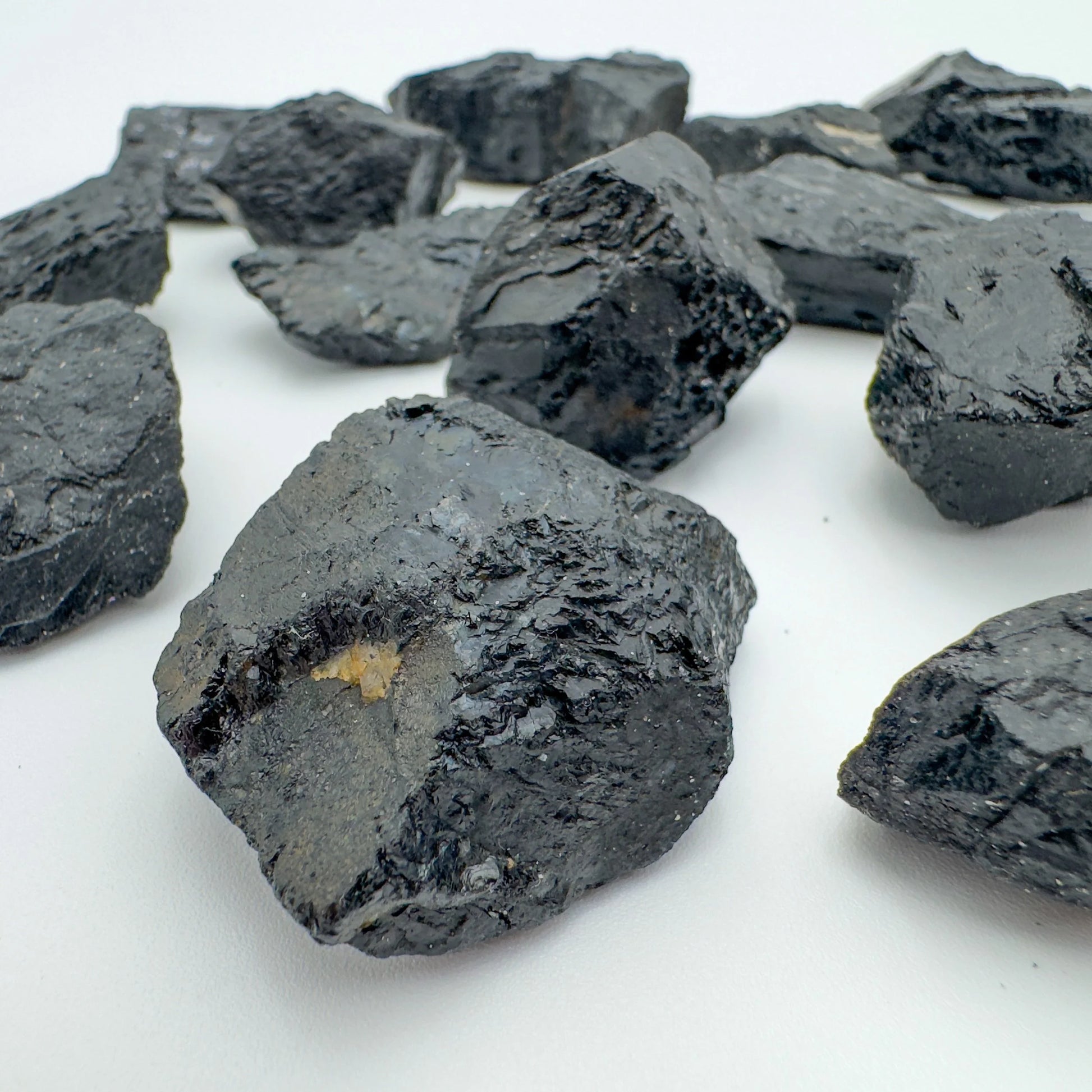 Top view of Black Tourmaline raw stone, carried for Protection and Grounding, showing natural color depth.