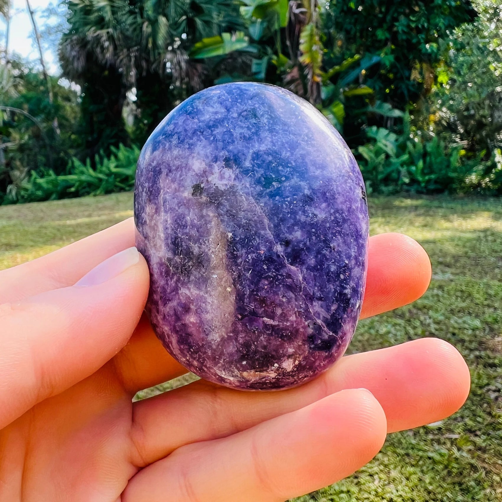 Close-up of Lepidolite palm stone from Madagascar, soothing wellness stone for Emotional Healing