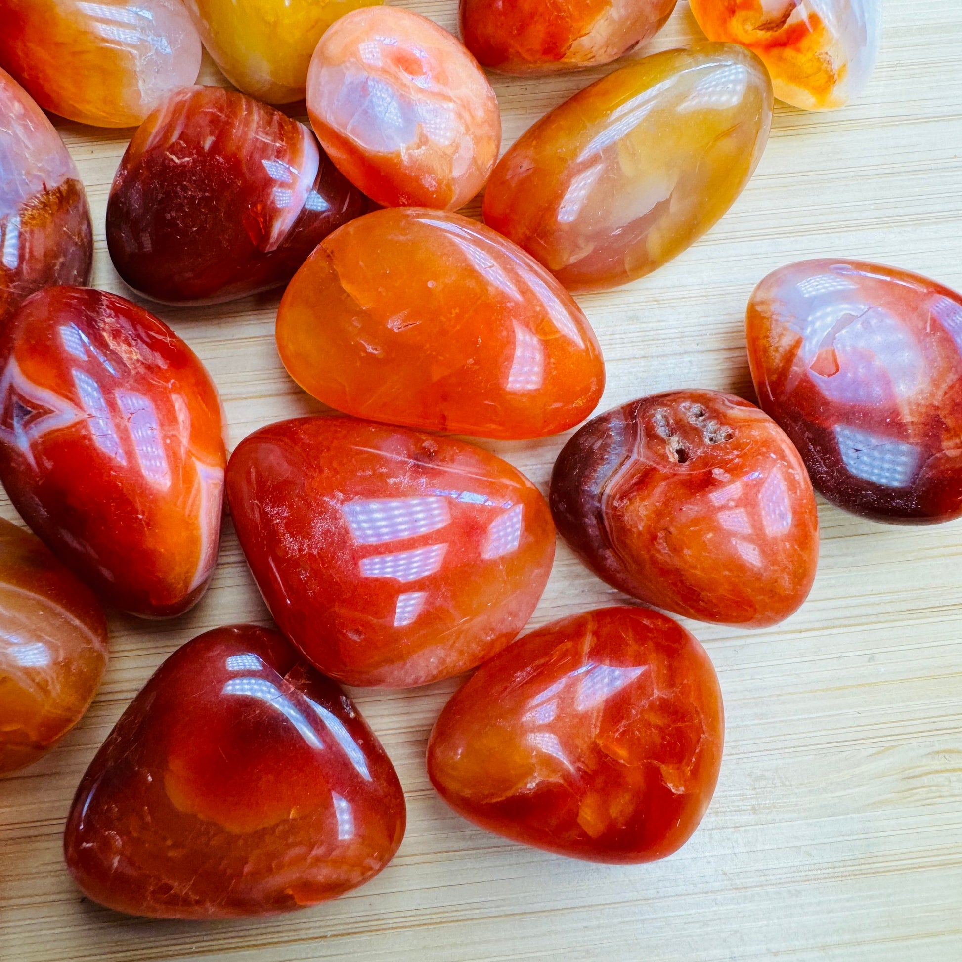 Top view of Grade AA Carnelian tumbled stone, sourced from Boeny, Madagascar