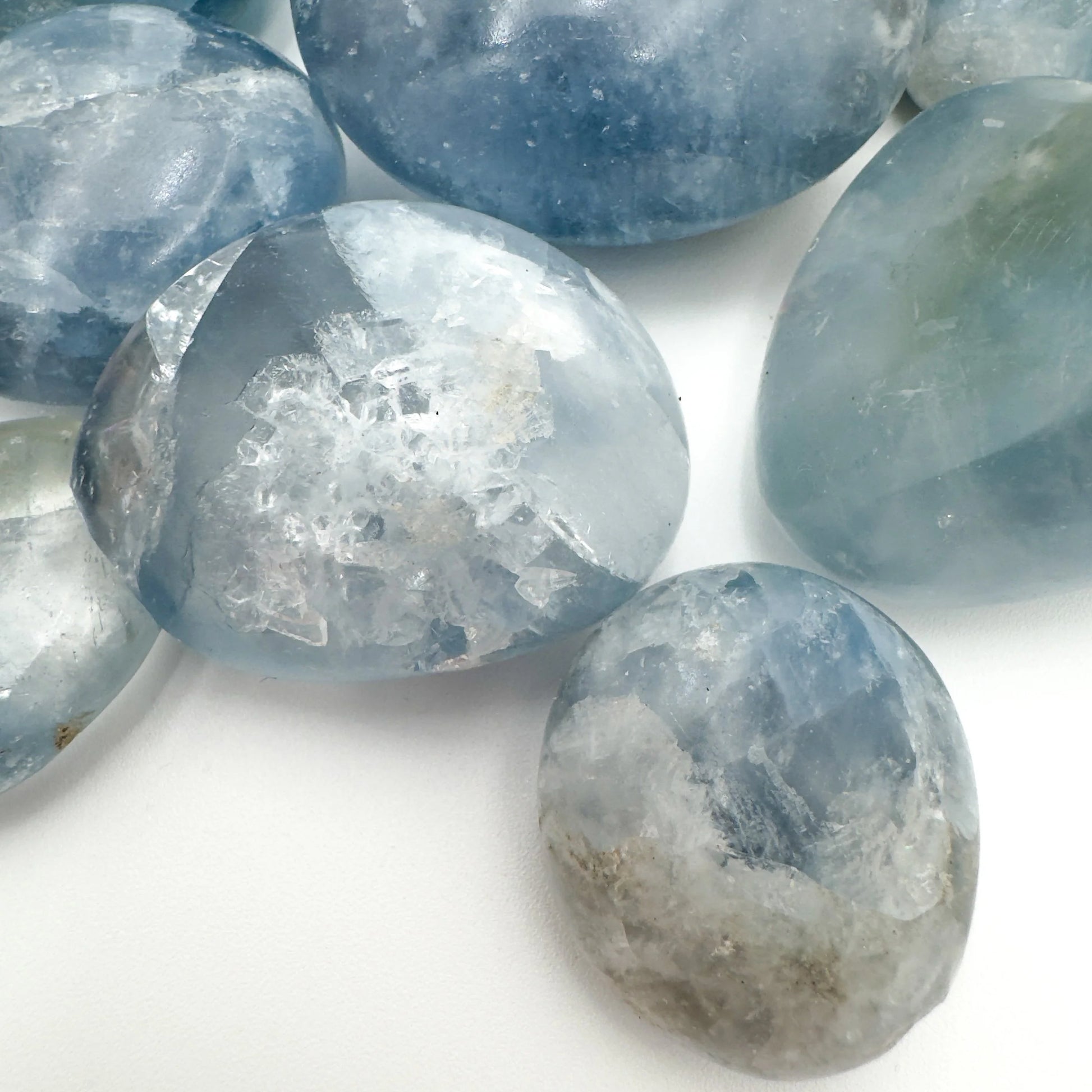 Celestite palm stone from Madagascar with Blue, Clear color, polished finish for mindful calm