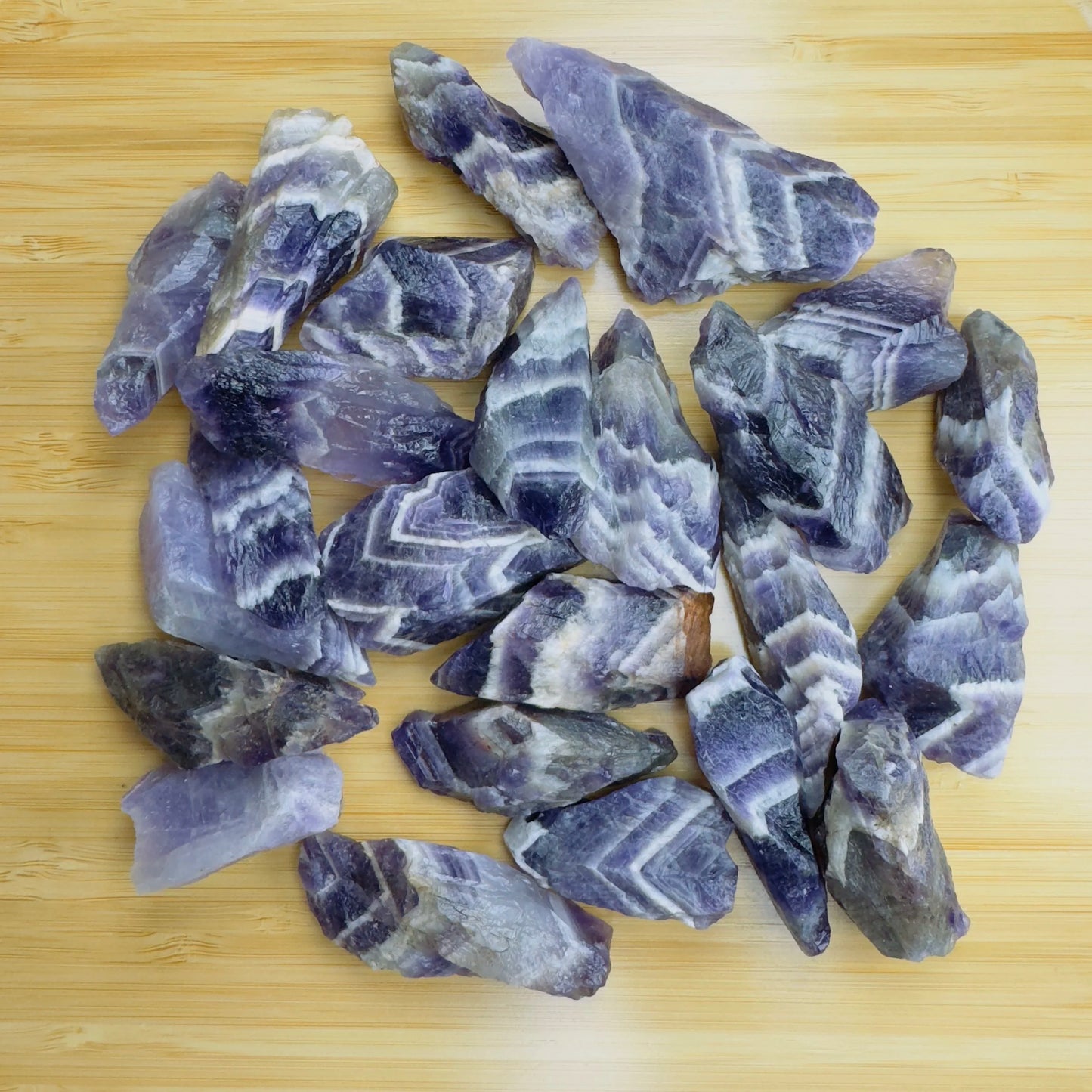 Close detail of purple Chevron Amethyst raw stone, often kept for Intuition and Meditation.