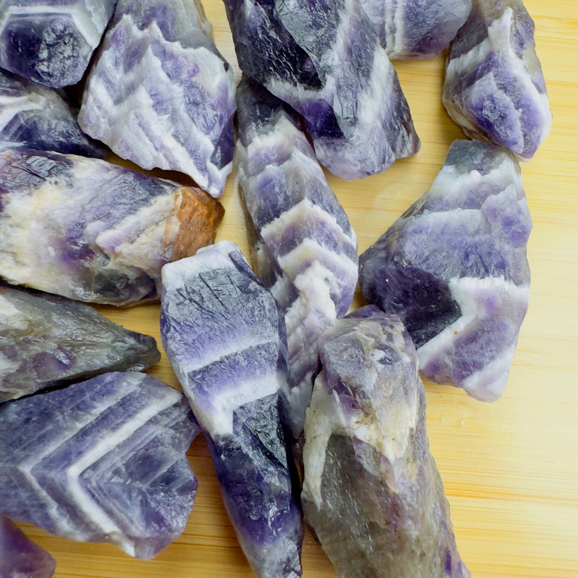 Overhead angle of Grade AA purple Chevron Amethyst raw stone, Zambia-sourced, to support Intuition.