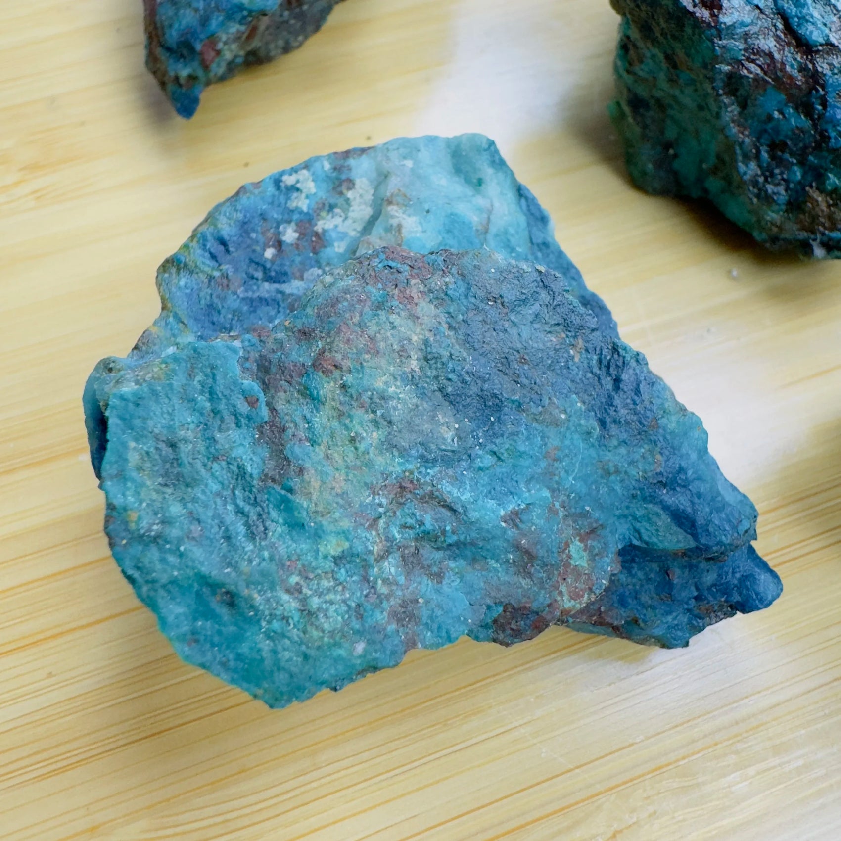 Aerial view of blue Chrysocolla raw stone, sourced from Kunene, Namibia, to support Emotional Healing.
