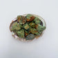 Texture-level view of Chrysoprase raw stone, showing earthy tone.