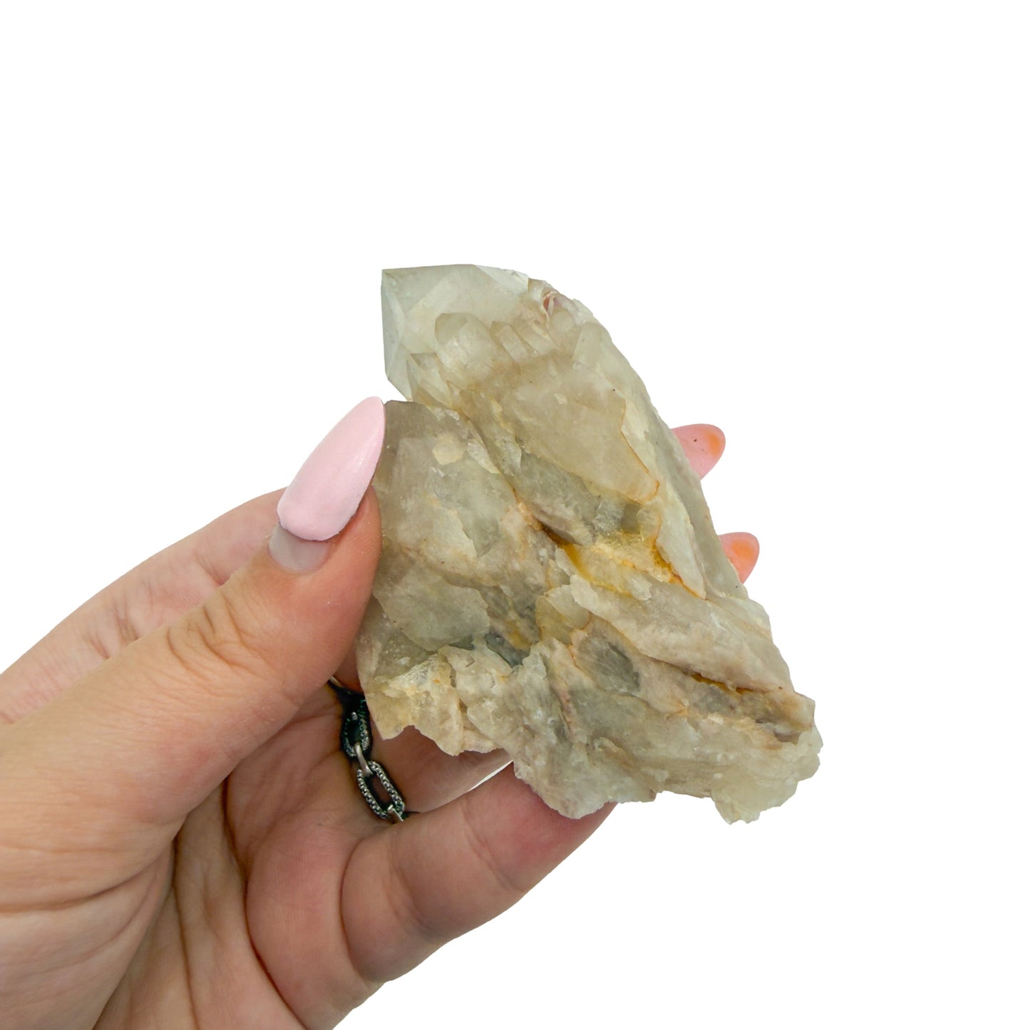 A hand holds citrine cluster no. 22 for scale, the 0.27 lb specimen sitting across the palm at 3.45 inches.