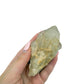 Citrine cluster no. 24 cupped in a hand, giving a sense of its 1.81 inch height and 0.35 pound weight.
