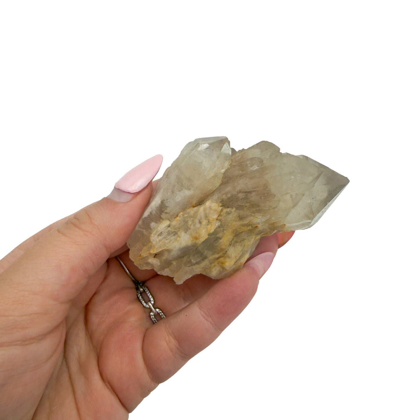 A hand holds citrine cluster no. 27 for scale, the 0.27 lb specimen sitting across the palm at 2.58 inches.