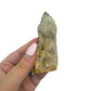 A hand holds citrine cluster no. 37 for scale, the 0.26 lb specimen sitting across the palm at 1.53 inches.