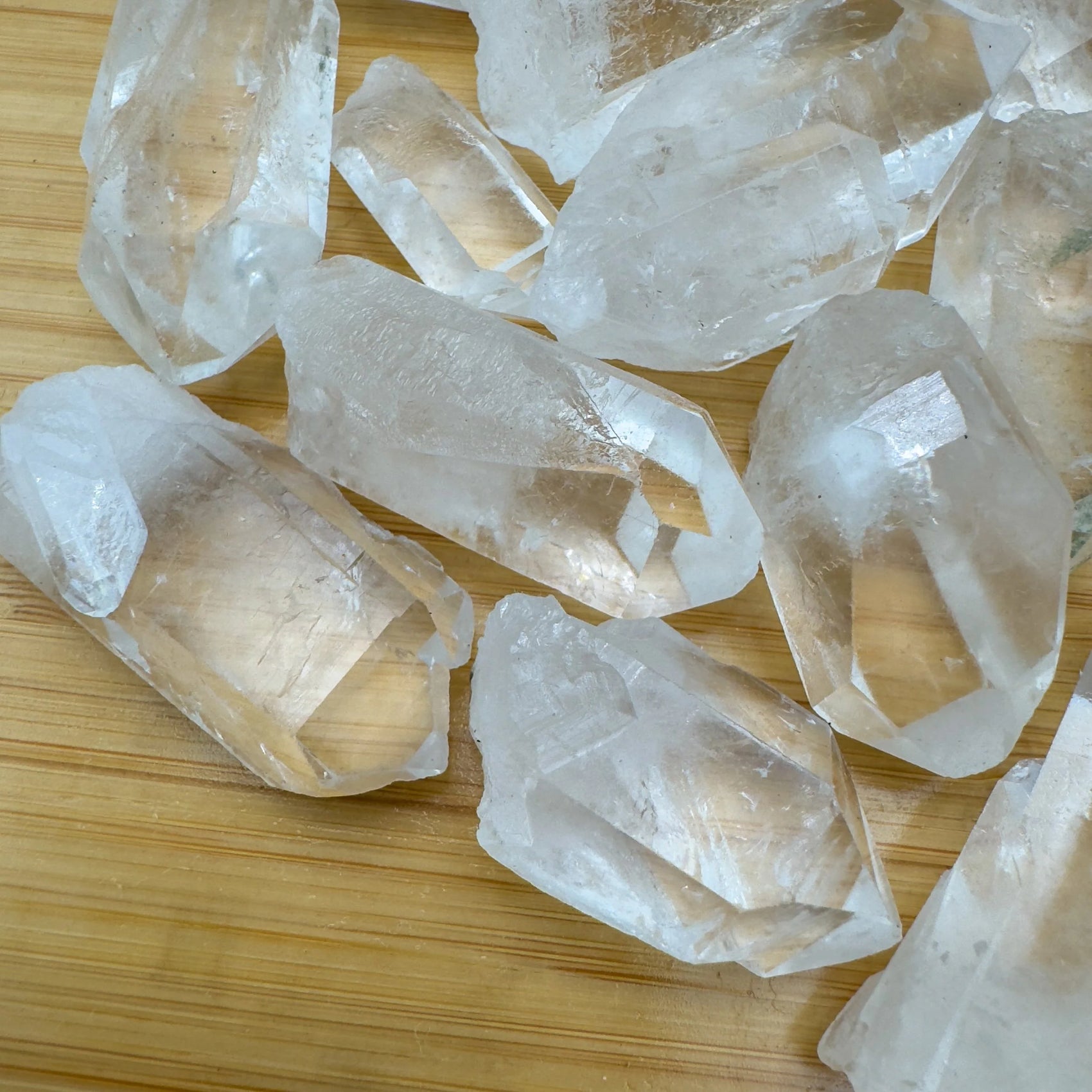 Side profile of Clear Quartz raw point, showing subtle veining, to support Cleansing.