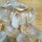 Bird's-eye view of Grade AA Clear Quartz raw point, showing natural texture.