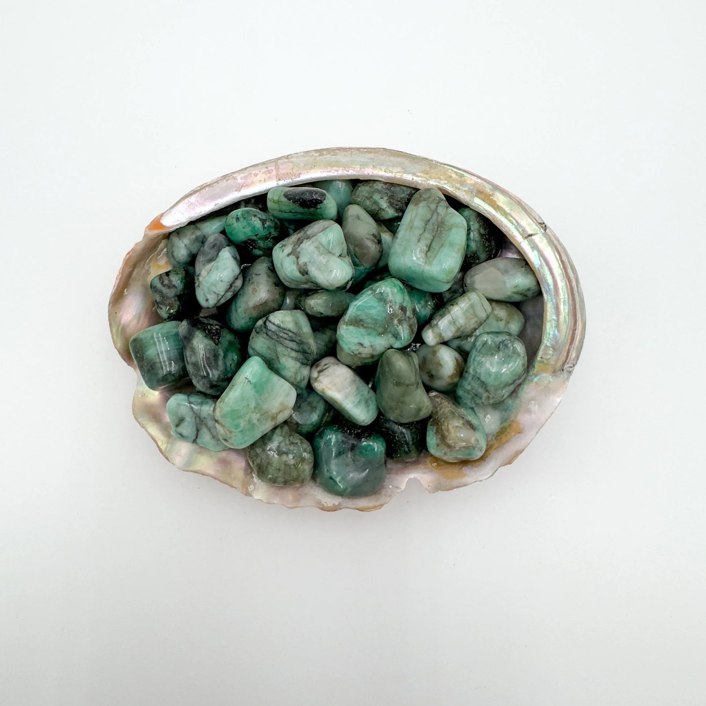 Detail shot showing Emerald tumbled stone, associated with Love.