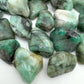 Side angle of Emerald tumbled stone, showing natural inclusions.