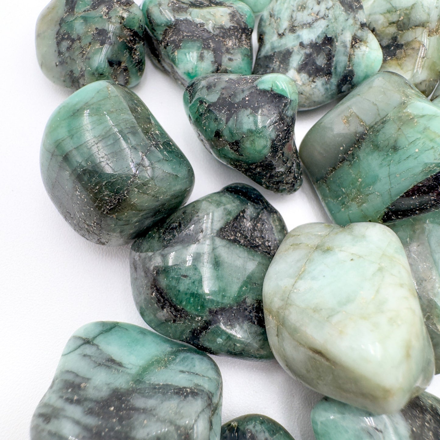Reverse side of Emerald tumbled stone, sourced from Brazil, associated with Love.