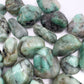Scale reference of one Emerald tumbled stone for scale, from Bahia, Brazil.