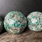 Detail shot of Grade AA Emerald sphere under natural light
