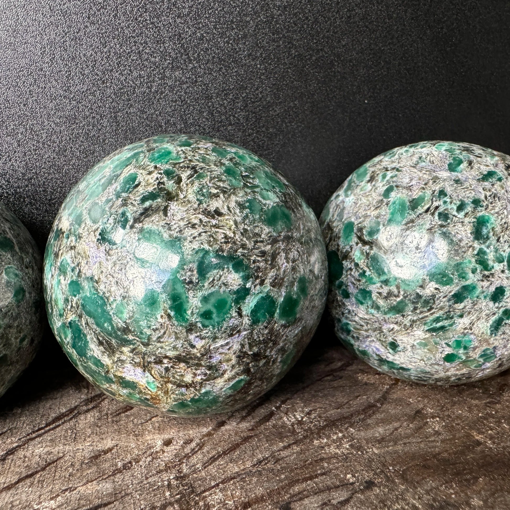 Detail shot of Grade AA Emerald sphere under natural light