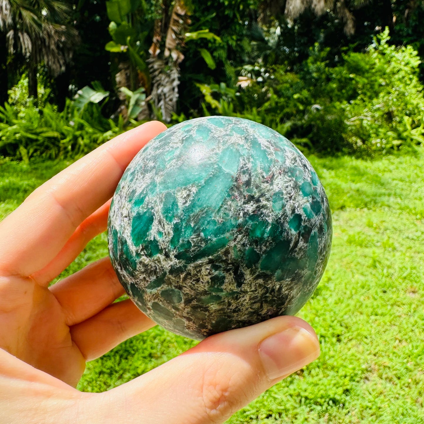 Underside view of Emerald polished sphere, showing subtle veining, from Zimbabwe.