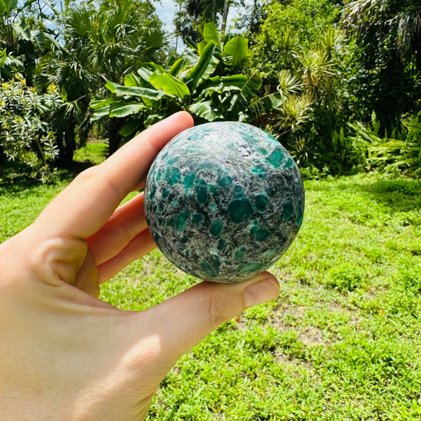 Grain detail of Emerald polished sphere, showing translucent edges.