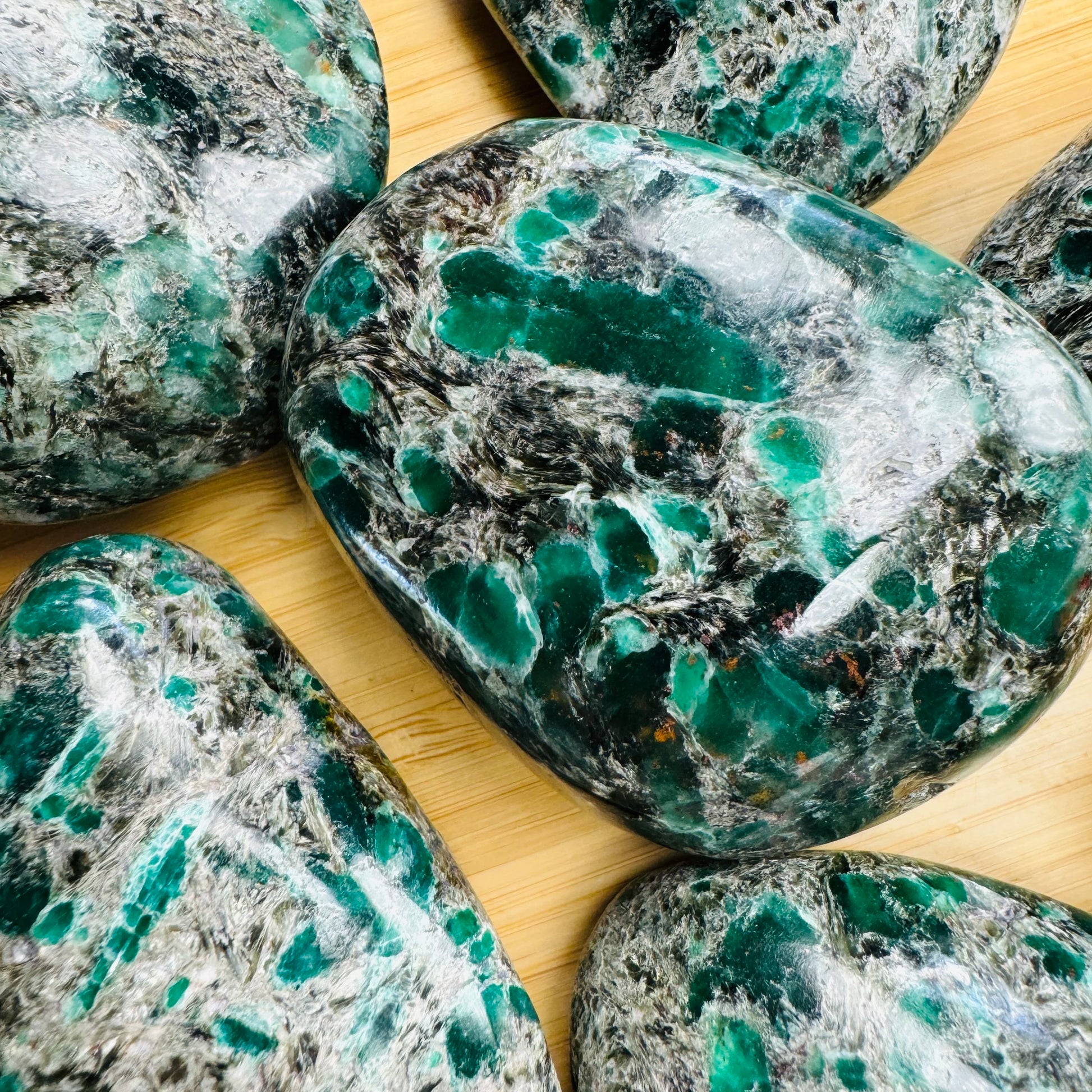 Grade aa emerald palm stone held in hand for size reference