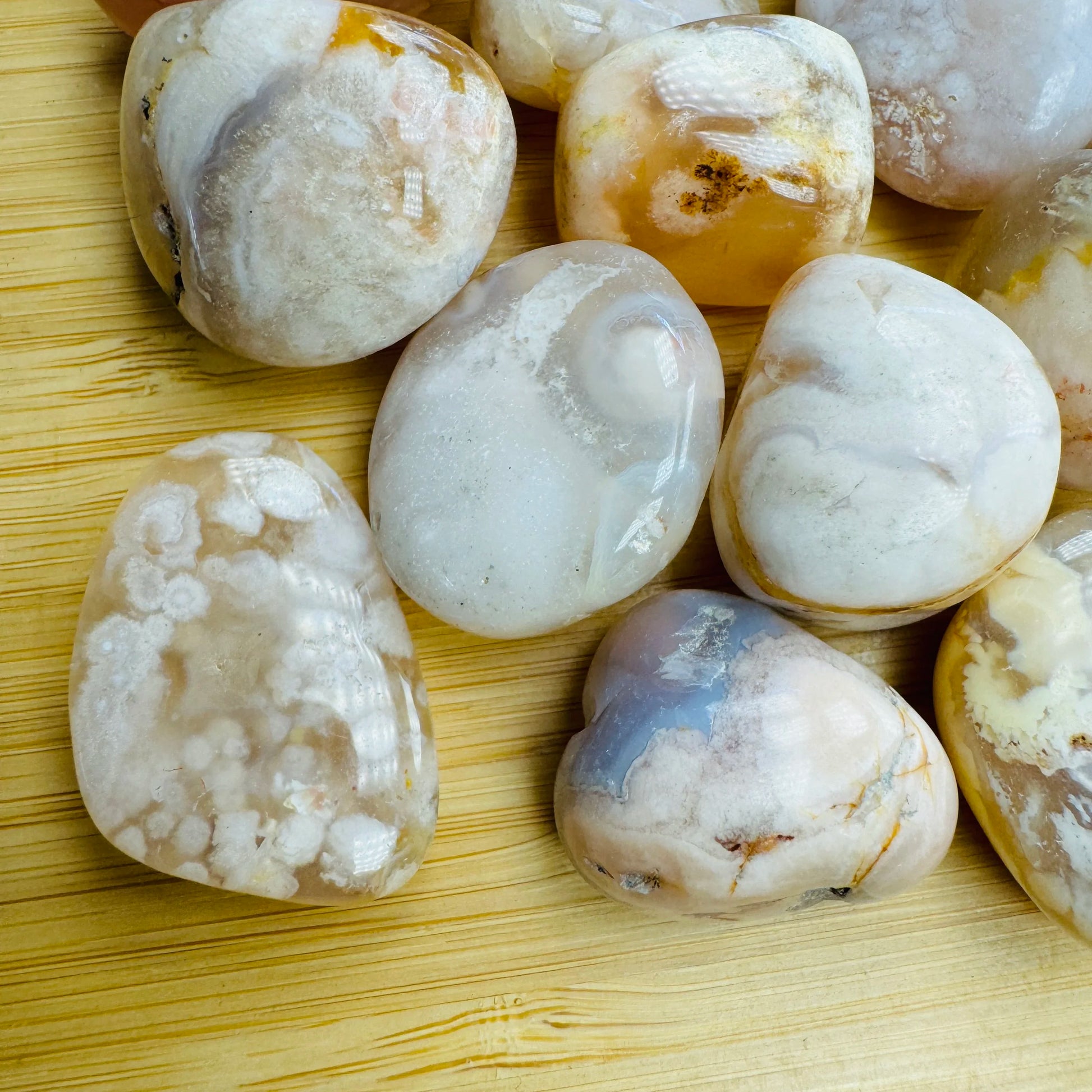 Side angle of Flower Agate tumbled stone, showing characteristic finish, sourced from Madagascar.