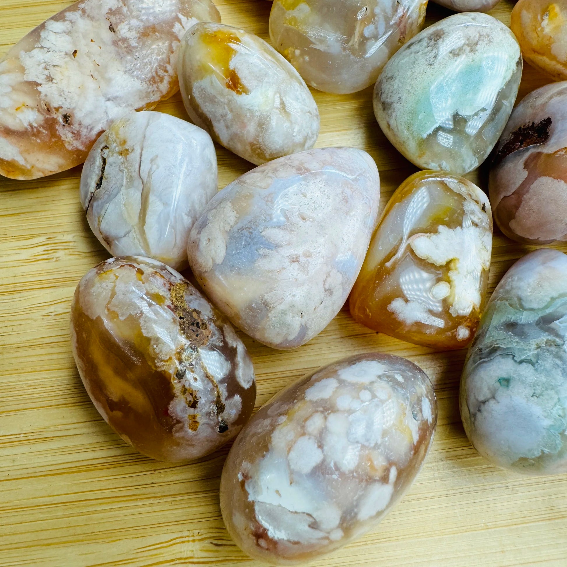 Side perspective of Flower Agate tumbled stone, carried for Love, hand-selected from Analamanga, Madagascar.