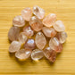 Detail shot of Grade AA Fire Quartz tumbled stone under natural light