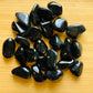 Back view of Grade AA Rainbow Obsidian tumbled stone showing natural surface