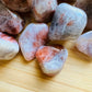 Macro view of Sunstone tumbled stone, for Confidence, showing natural variation.