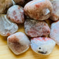 Sideways view of Grade AA Sunstone tumbled stone, from Morogoro, Tanzania, showing translucent edges.