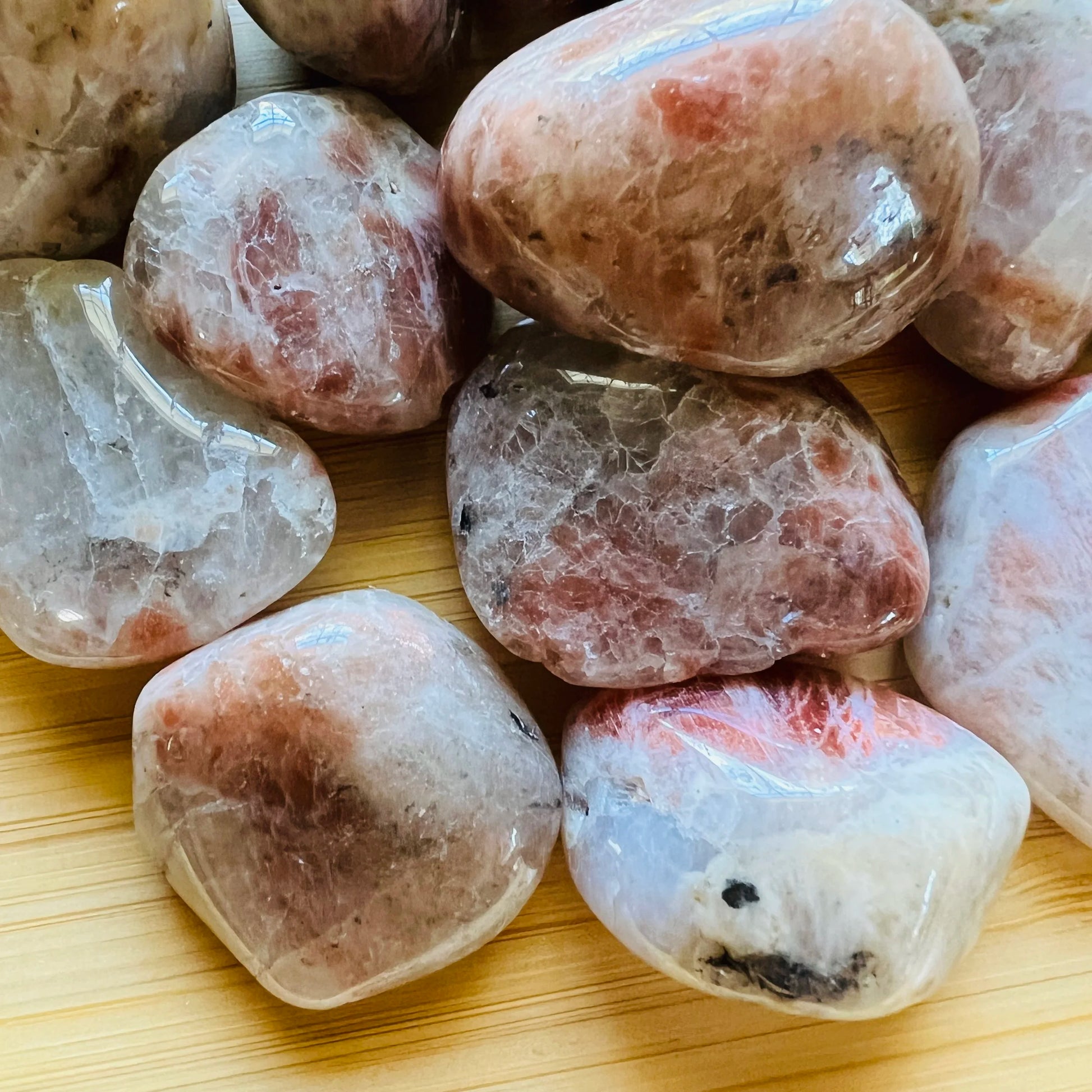 Sideways view of Grade AA Sunstone tumbled stone, from Morogoro, Tanzania, showing translucent edges.
