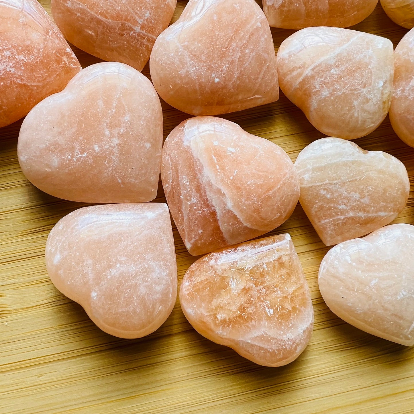Detail shot showing Grade AA Orange Calcite polished heart, showing natural inclusions.