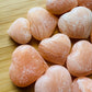 Underside detail of Orange Calcite polished heart, sourced from Mahajanga, Madagascar.
