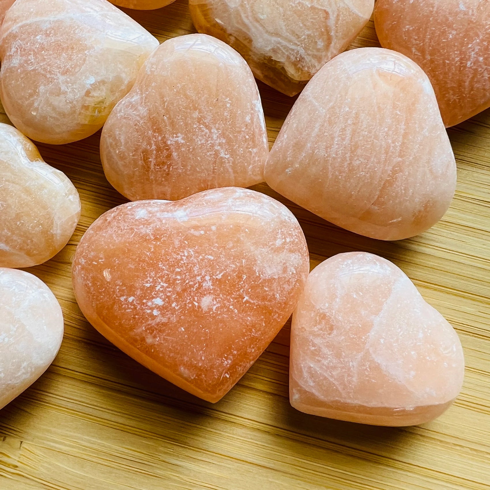 Side profile of Orange Calcite polished heart, from Madagascar.