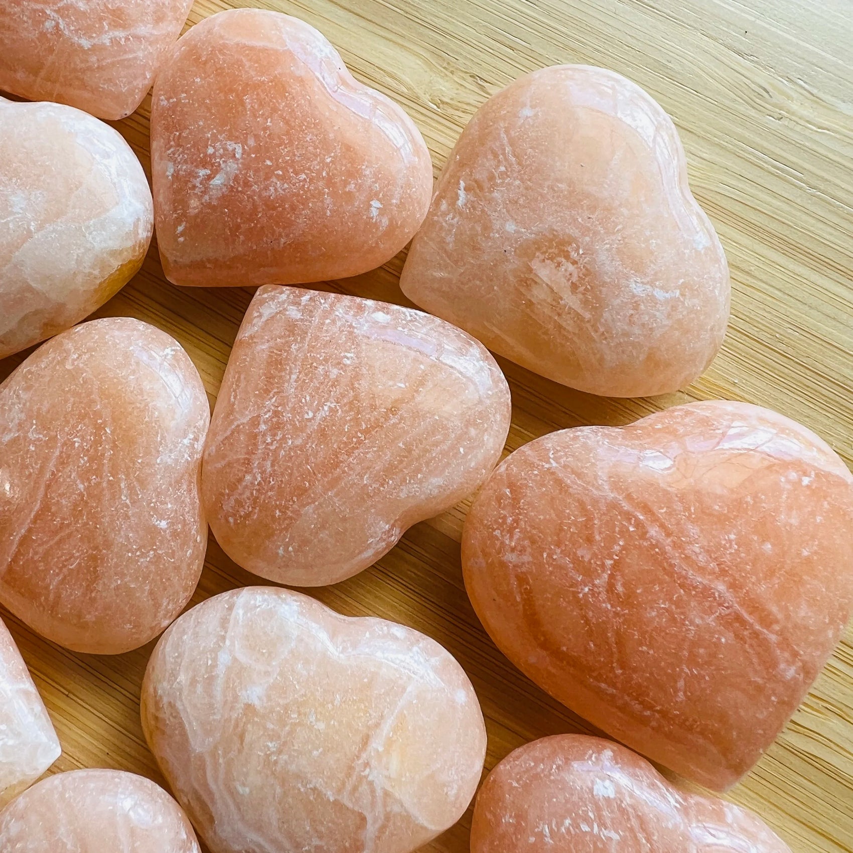 Bird's-eye view of Orange Calcite polished heart, showing earthy tone, sourced from Mahajanga, Madagascar.