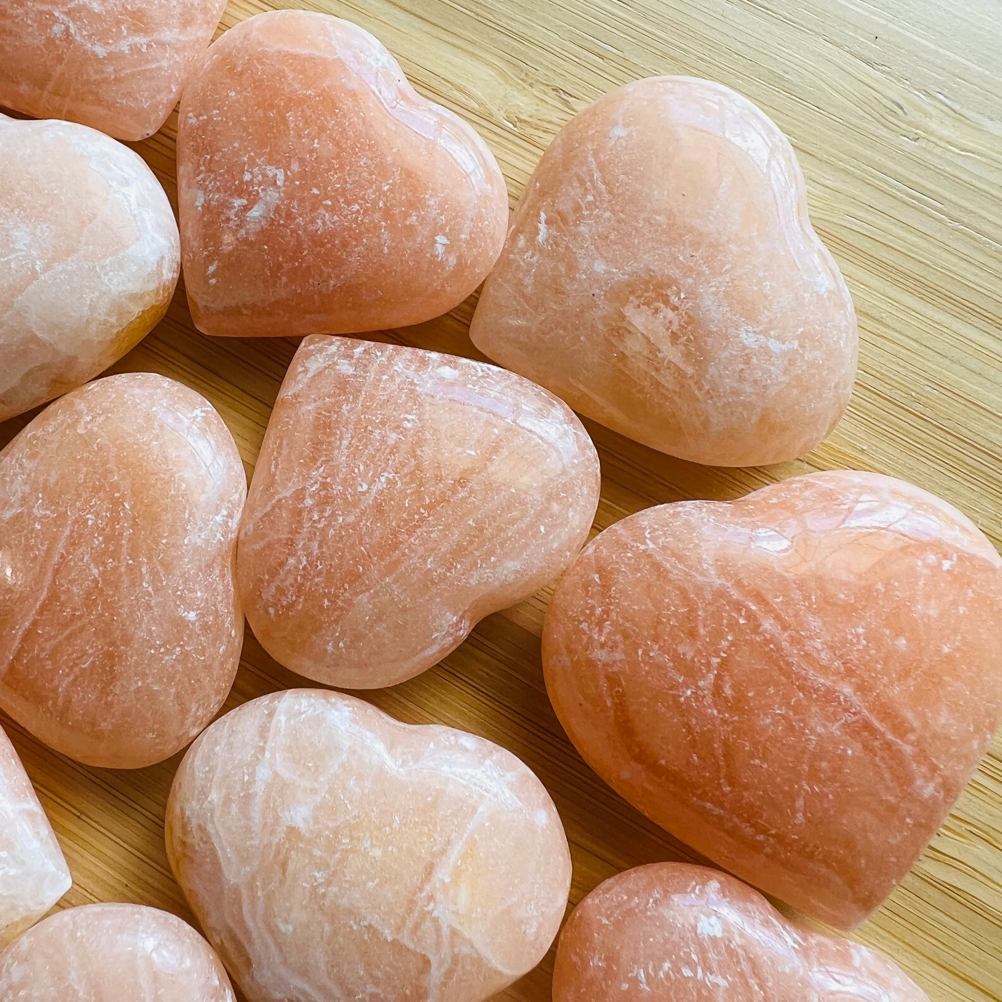 Bird's-eye view of Orange Calcite polished heart, showing earthy tone, sourced from Mahajanga, Madagascar.