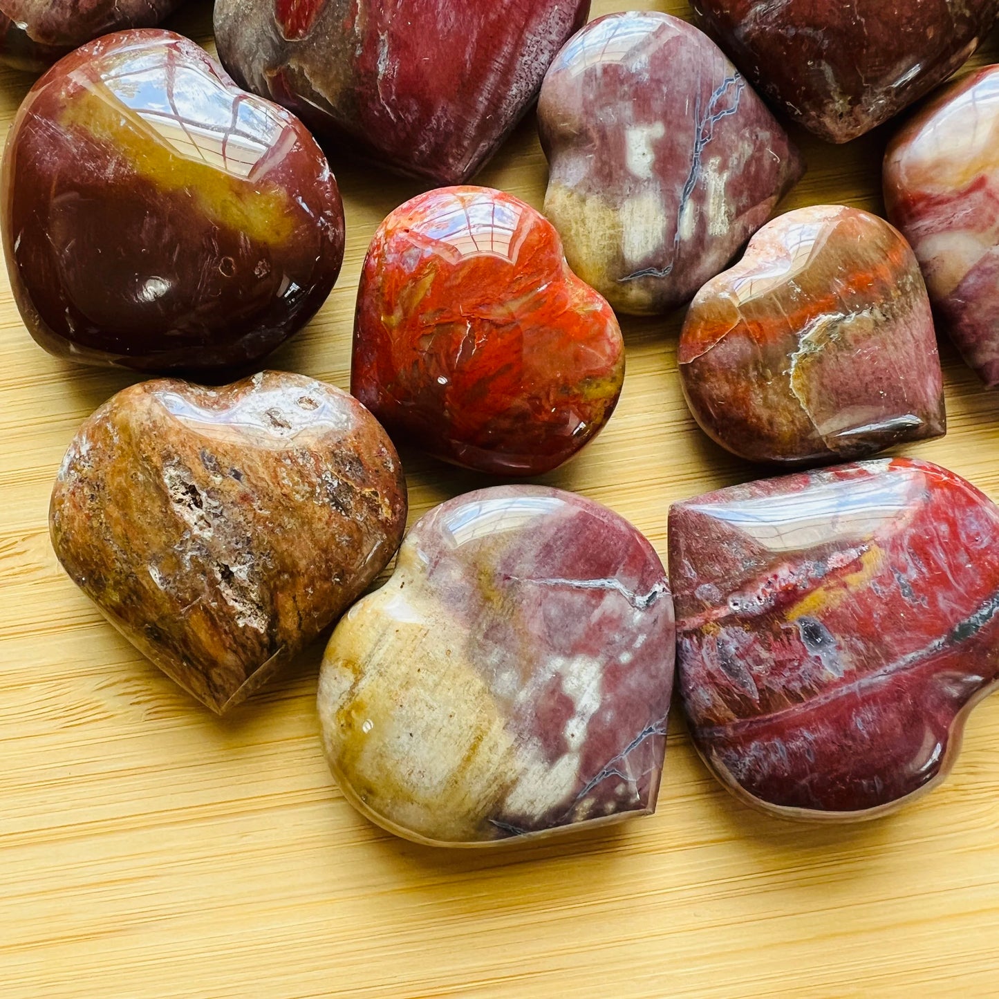 Tight crop of Petrified Wood polished heart, showing color depth.