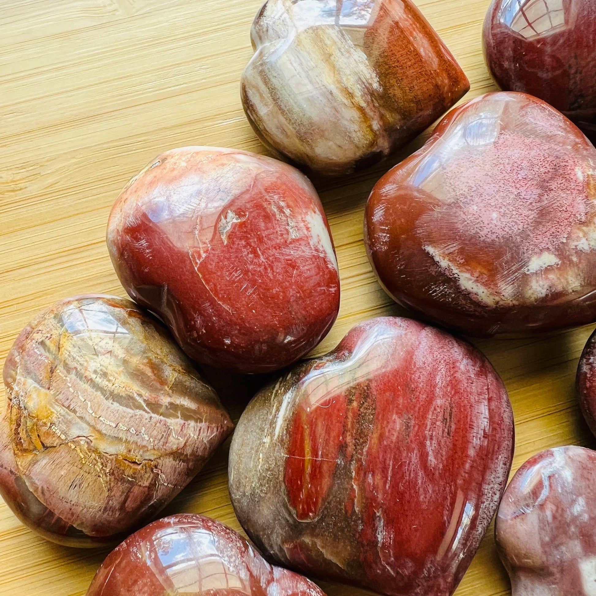 Profile shot of brown Petrified Wood polished heart, showing earthy tone, hand-selected from Boeny, Madagascar.