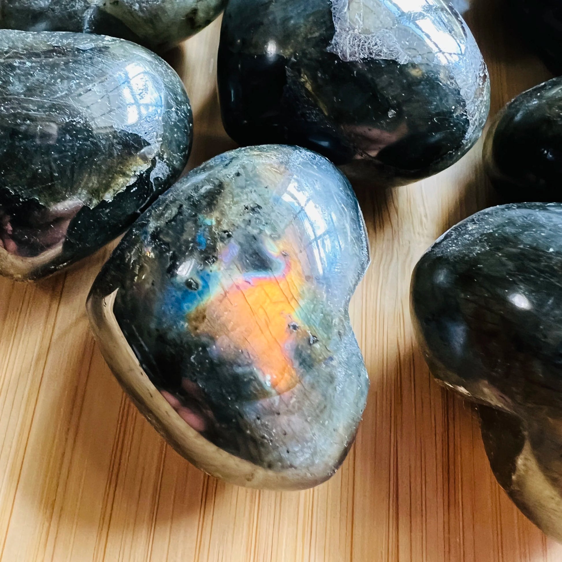 Close detail of Labradorite polished heart, kept near for Intuition, showing earthy tone.