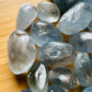 Side-on view of Grade AA Celestite tumbled stone, from Sakoany, Madagascar, traditionally used for Stress Relief and Sleep.