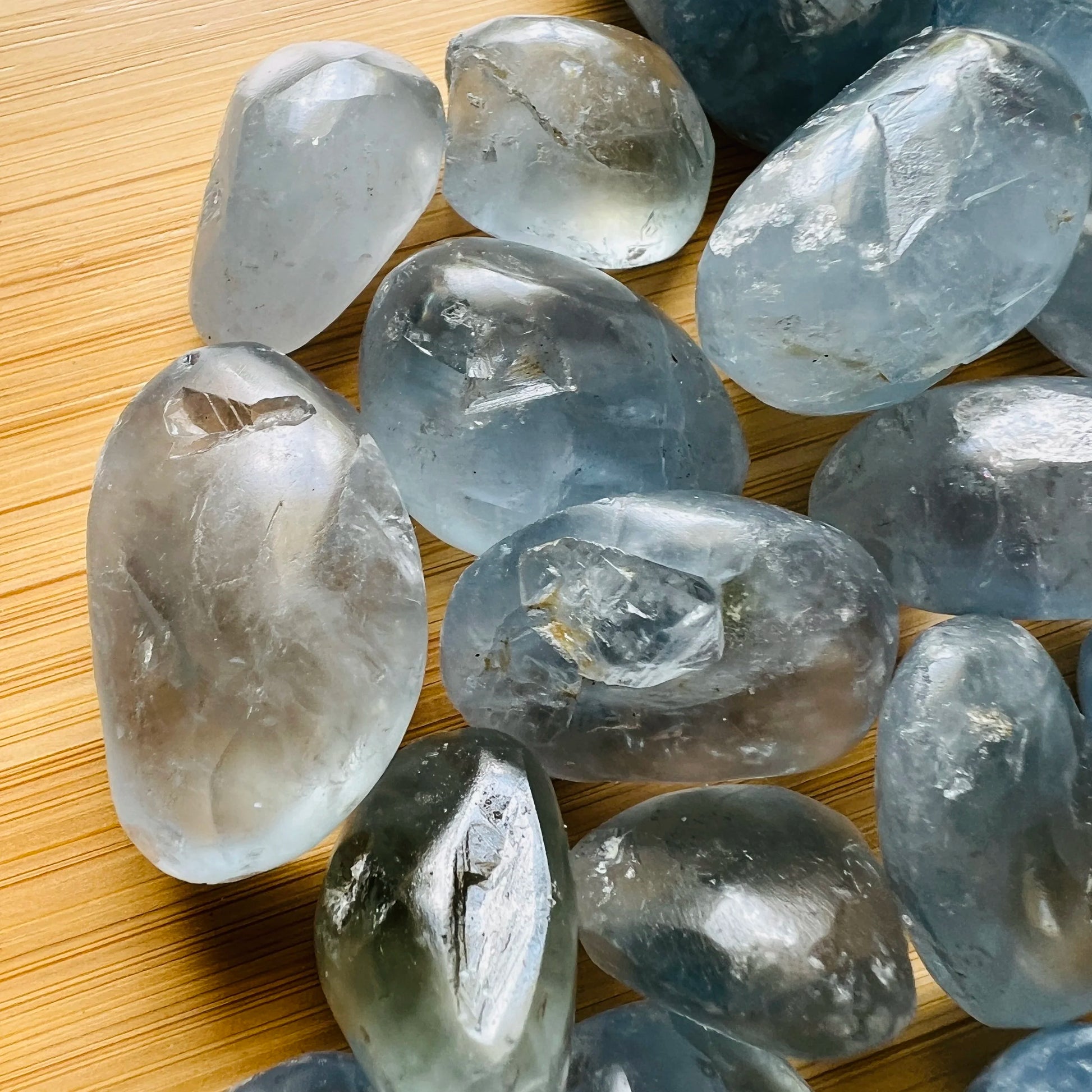 Side-on view of Grade AA Celestite tumbled stone, from Sakoany, Madagascar, traditionally used for Stress Relief and Sleep.