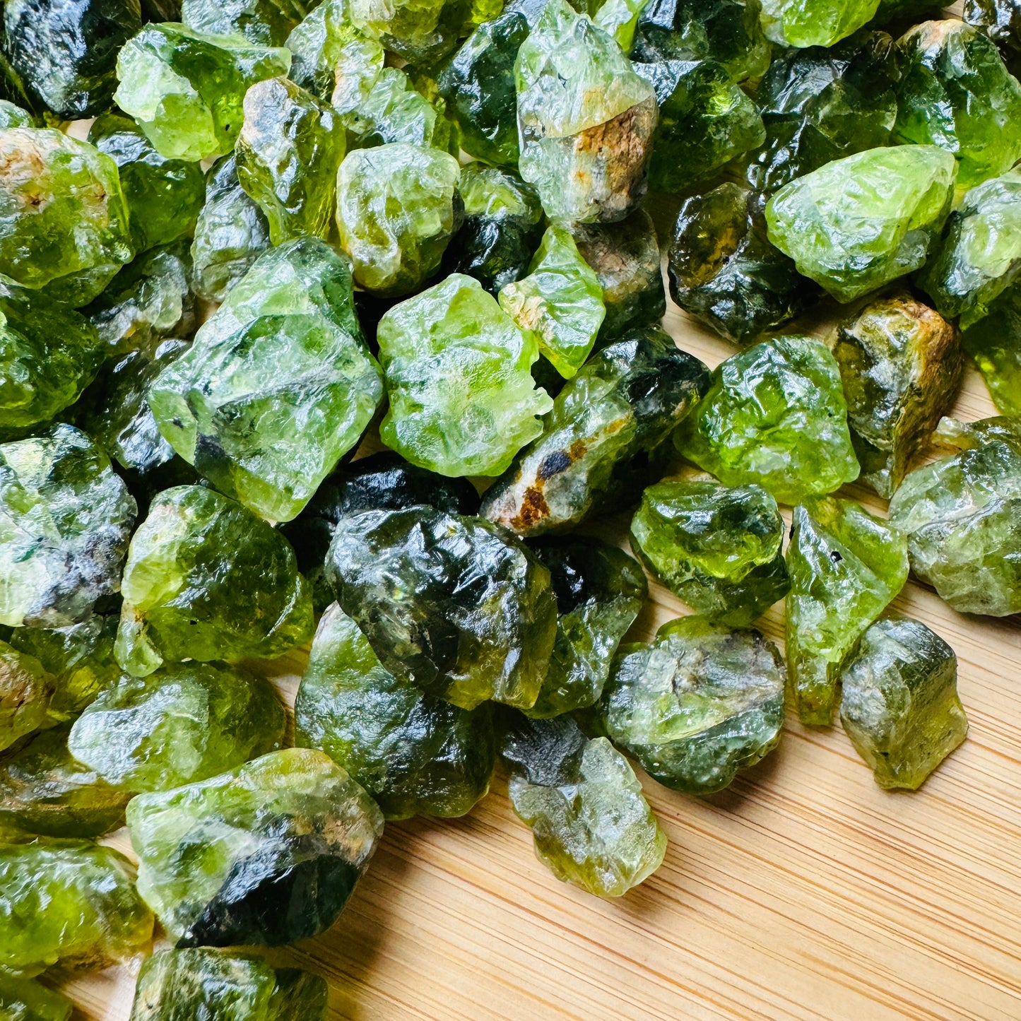 Back view of Peridot raw stone, kept close for Abundance, United States-sourced.
