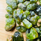 Top-down shot of Peridot raw stone, showing natural inclusions, hand-selected from San Carlos Apache Reservation, Arizona, United.