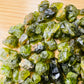 Side angle of Peridot raw stone, hand-selected from San Carlos Apache Reservation, Arizona, United States.