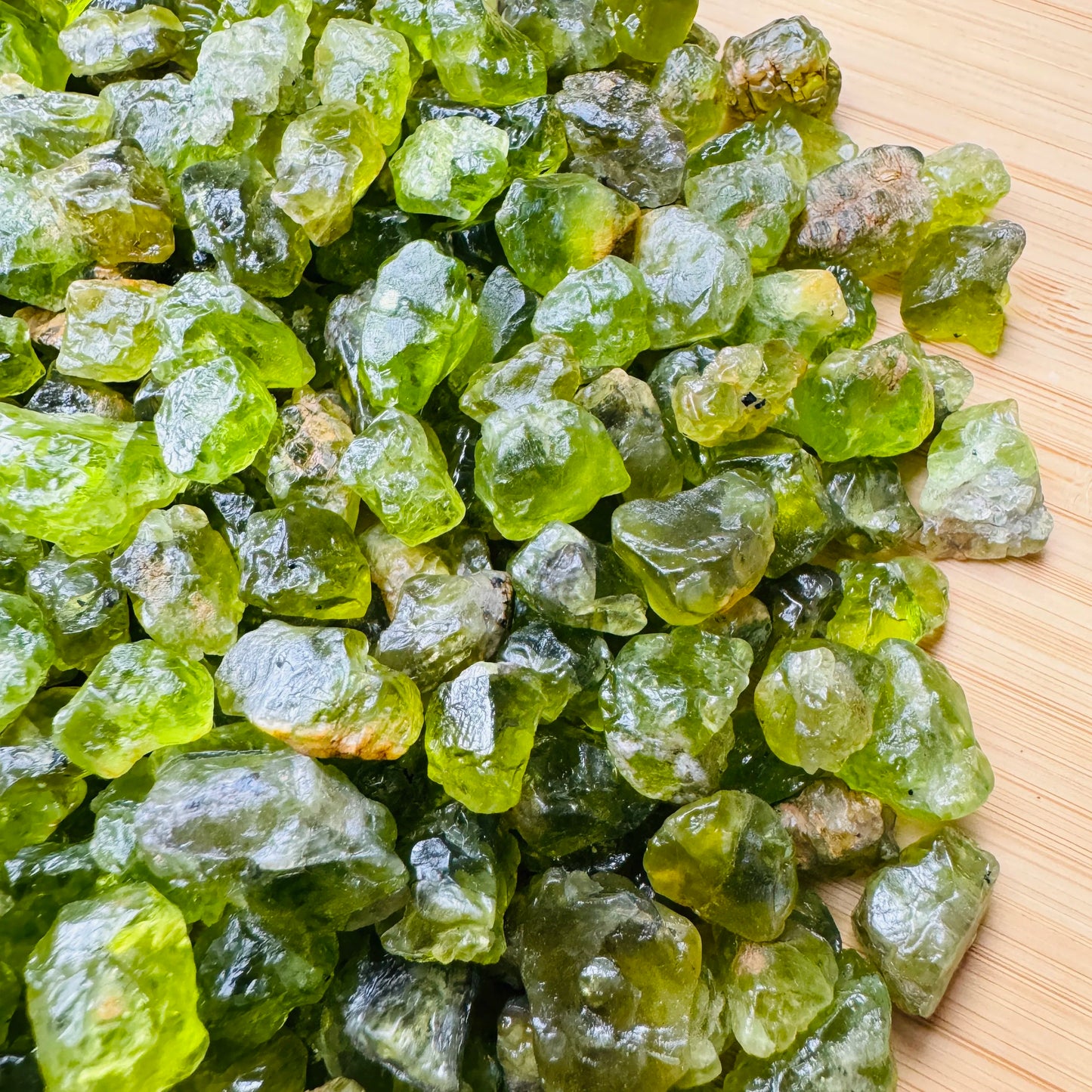 Underside view of green Peridot raw stone, showing characteristic color.