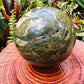 Styled with natural light Ocean Jasper stone, from Sofia, Madagascar, shown for proportion against the hand.