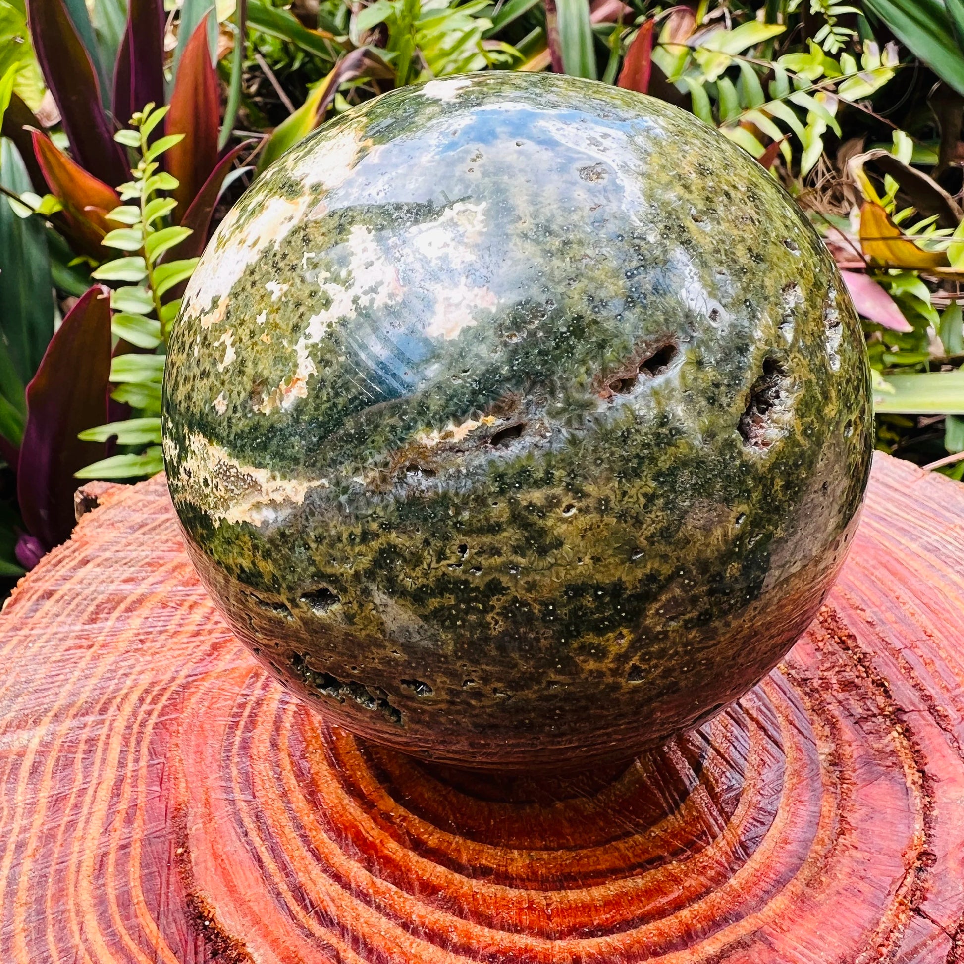 Styled with natural light Ocean Jasper stone, from Sofia, Madagascar, shown for proportion against the hand.